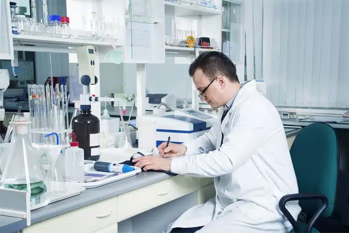 Analytical chemist working at a laboratory bench